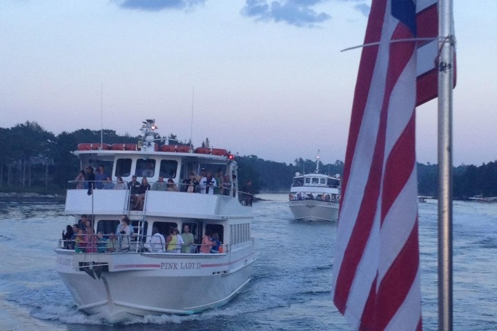 American Flag in foreground with Cap'n Fish's Cruise behind it