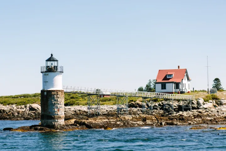 Boothbay Harbor fireworks cruise lighthouse on a rocky point